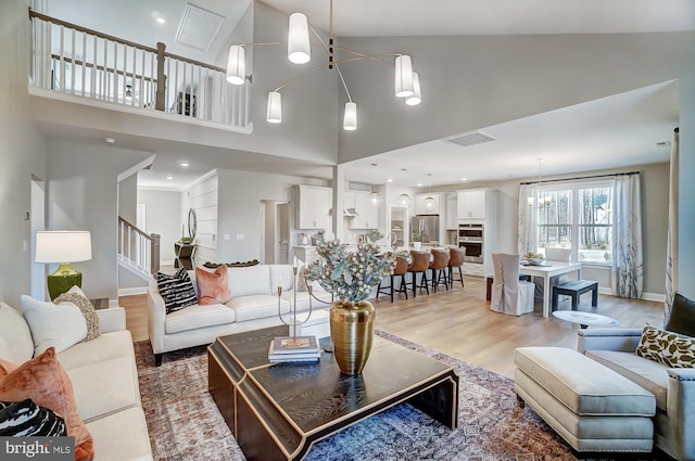 751 Bowie Shop Rd, Huntingtown, MD 20639 - living room with visible vents, high vaulted ceiling, stairway, light wood-style floors, and baseboards