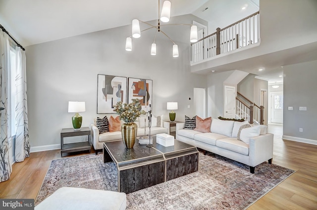 751 Bowie Shop Rd, Huntingtown, MD 20639 - living room with high vaulted ceiling, stairs, baseboards, and wood finished floors