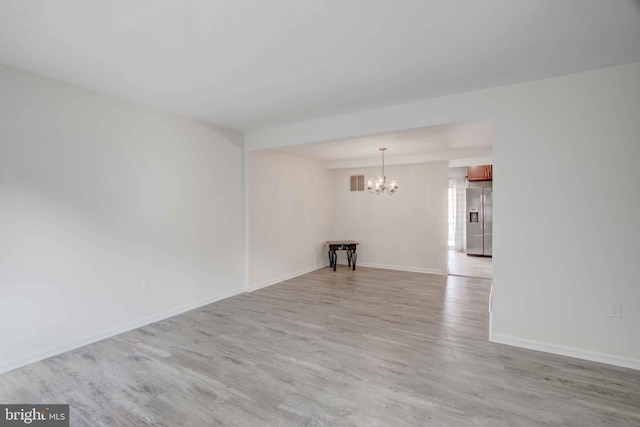 14613 Tynewick Ter Unit 6-1461, Silver Spring, MD 20906 - spare room with baseboards, light wood-style floors, a chandelier, and visible vents