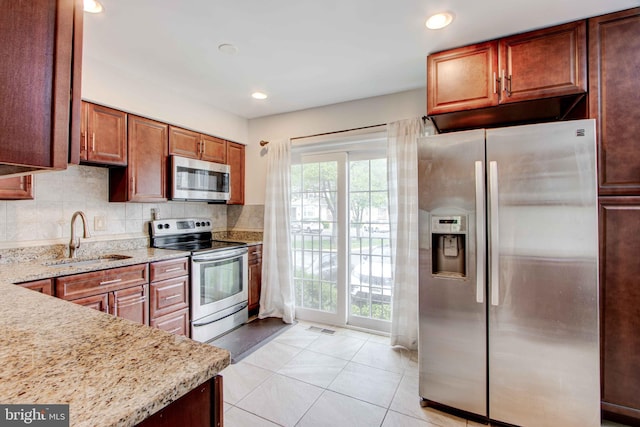 14613 Tynewick Ter Unit 6-1461, Silver Spring, MD 20906 - kitchen featuring a sink, stainless steel appliances, light tile patterned flooring, light stone counters, and visible vents
