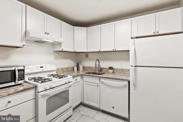 1260 21st St NW Unit 911, Washington, DC 20036 - kitchen with white appliances, under cabinet range hood, a sink, light marble finish flooring, and white cabinetry