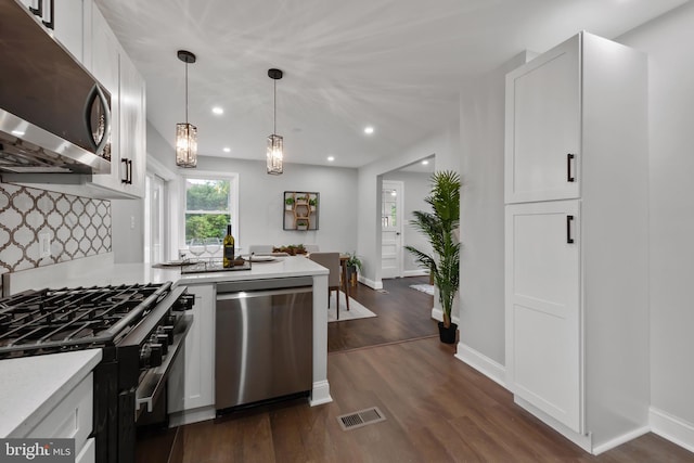 6611 Loch Hill Rd, Baltimore, MD 21239 - kitchen with appliances with stainless steel finishes, light countertops, recessed lighting, dark wood-style floors, and white cabinetry
