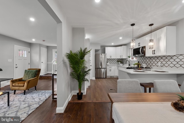 6611 Loch Hill Rd, Baltimore, MD 21239 - dining space featuring dark wood-type flooring and recessed lighting