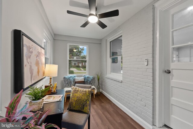6611 Loch Hill Rd, Baltimore, MD 21239 - living area featuring brick wall, a ceiling fan, and dark wood-style floors