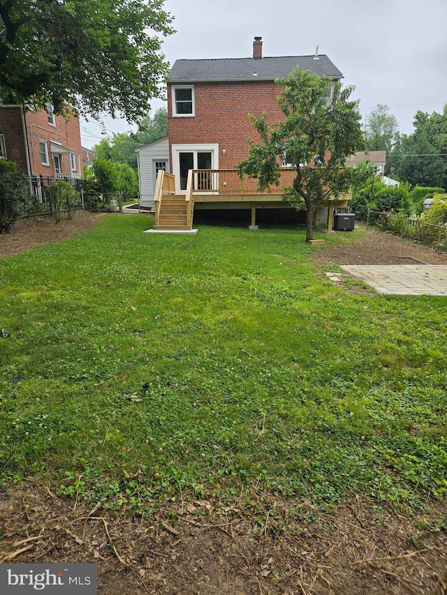 6611 Loch Hill Rd, Baltimore, MD 21239 - back of property featuring a deck, a chimney, and brick siding
