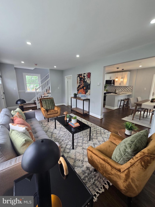 6611 Loch Hill Rd, Baltimore, MD 21239 - living room with dark wood-style flooring, stairs, and recessed lighting