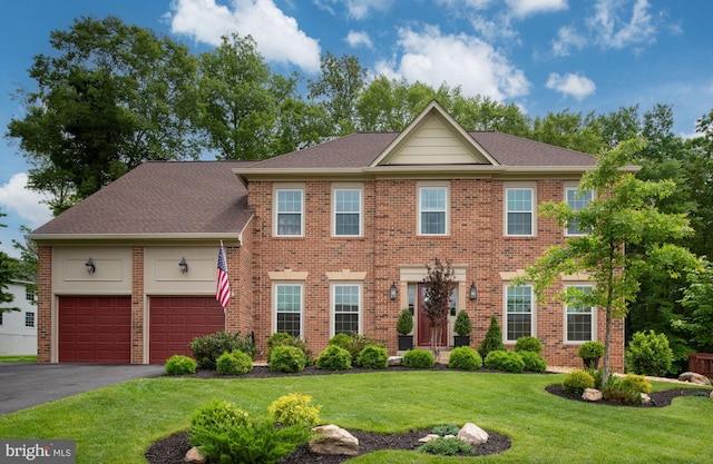 47 Christopher Way, Stafford, VA 22554 - view of front of property featuring a garage, driveway, a front lawn, brick siding, and a shingled roof