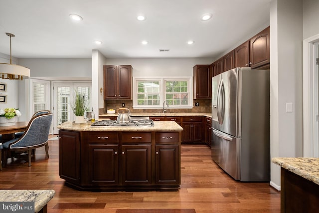 47 Christopher Way, Stafford, VA 22554 - kitchen with stainless steel appliances, decorative backsplash, wood finished floors, dark brown cabinetry, and a sink