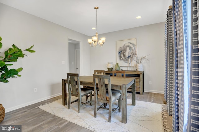 dining room with recessed lighting, a notable chandelier, wood finished floors, and baseboards