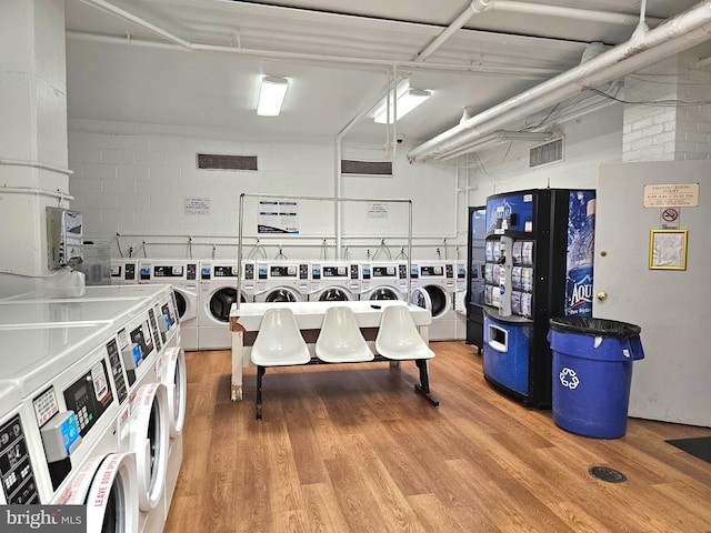 5340 Holmes Run Pkwy Unit 1410, Alexandria, VA 22304 - community laundry featuring light wood-style floors, stacked washer and clothes dryer, and washing machine and clothes dryer