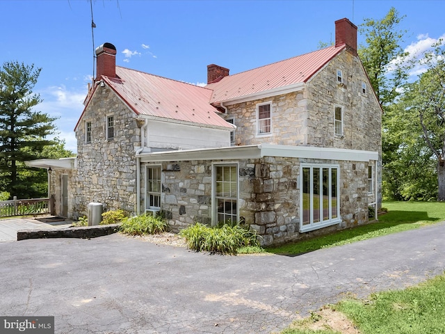 8805 Reichard Rd, Fairplay, MD 21733 - back of house with a chimney, stone siding, and metal roof