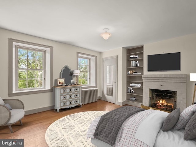 8805 Reichard Rd, Fairplay, MD 21733 - bedroom featuring radiator, baseboards, a fireplace, and light wood-style floors