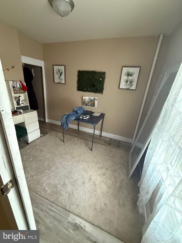 office featuring baseboards and wood finished floors