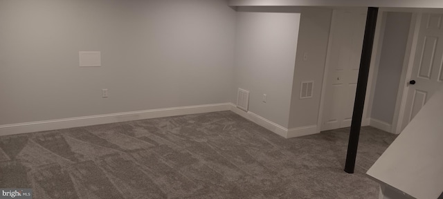 finished below grade area featuring visible vents, carpet floors, and baseboards