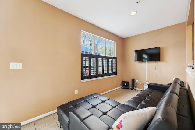 tiled living room featuring baseboards and recessed lighting