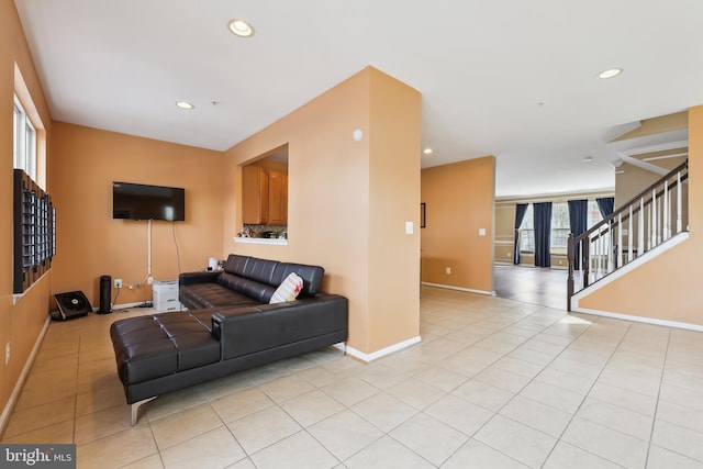 living room with stairway, recessed lighting, and light tile patterned floors