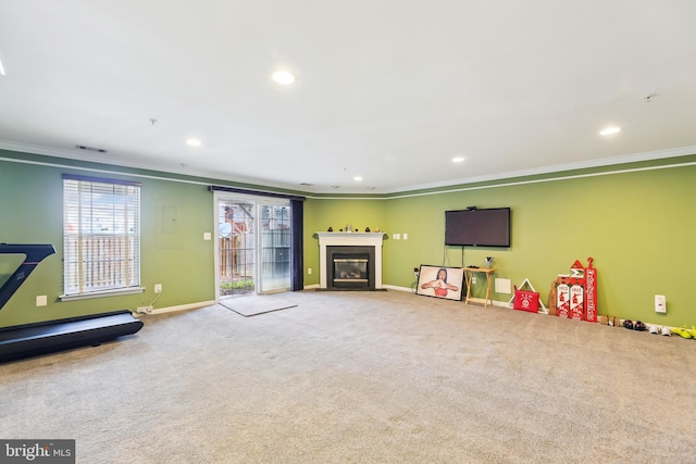 rec room featuring baseboards, ornamental molding, carpet, recessed lighting, and a fireplace with flush hearth