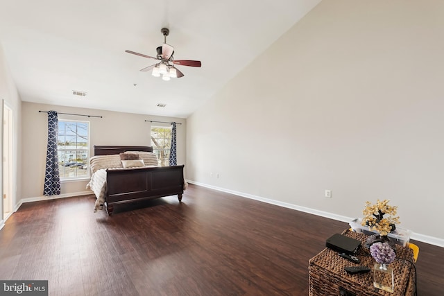 bedroom with visible vents, dark wood-style flooring, baseboards, and vaulted ceiling
