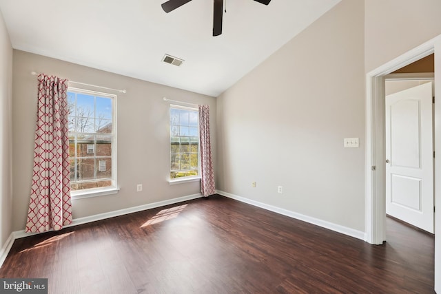 unfurnished room with visible vents, baseboards, a ceiling fan, dark wood-type flooring, and lofted ceiling