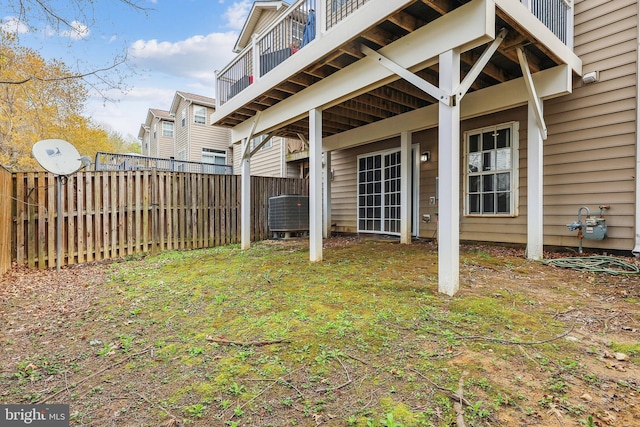 view of yard with central AC unit and fence