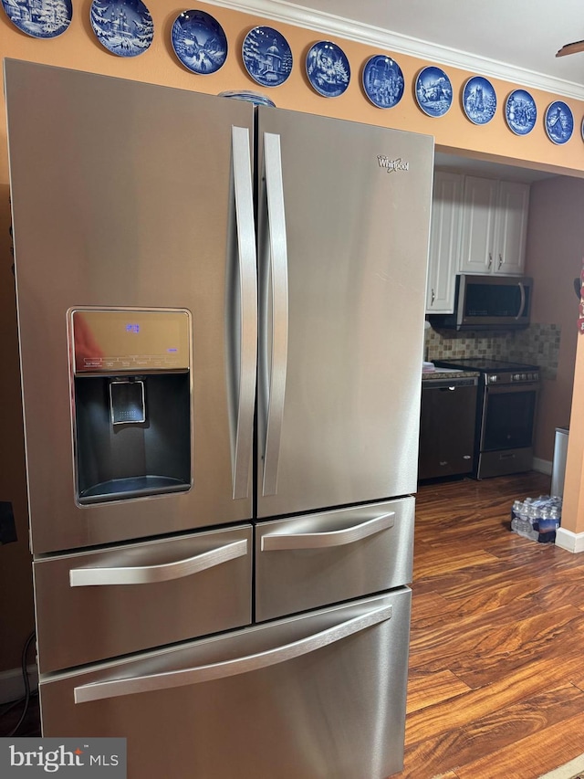 10020 Dakin Ct, Cheltenham, MD 20623 - kitchen view of appliances with stainless steel finishes, dark wood-style flooring, tasteful backsplash, white cabinetry, and baseboards