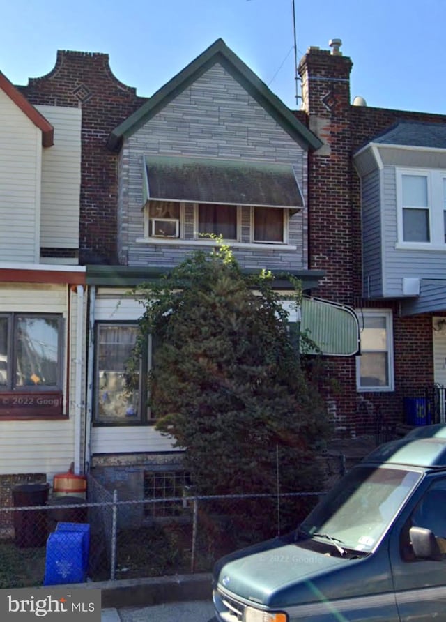 view of front of home featuring fence