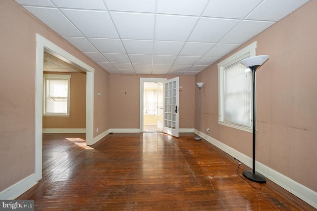 1405 Siegel Ave, Chester, PA 19013 - unfurnished living room featuring hardwood / wood-style floors, a drop ceiling, and baseboards