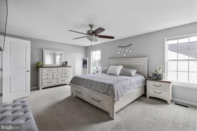 bedroom with multiple windows, baseboards, carpet, and ceiling fan