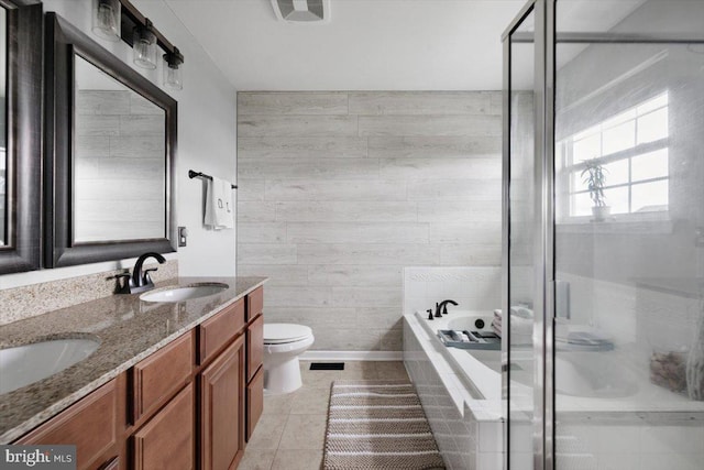 full bath with a sink, a garden tub, a shower stall, and tile patterned floors