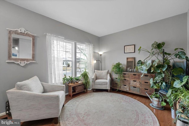 sitting room featuring baseboards and wood finished floors