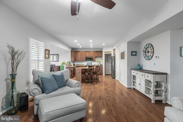 living area with dark wood finished floors, recessed lighting, baseboards, and a ceiling fan