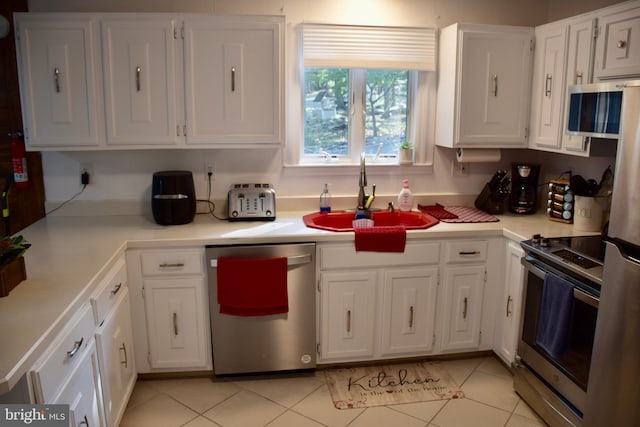 kitchen featuring white cabinetry and stainless steel appliances