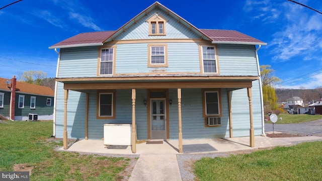 8354 Cumberland Rd, Springfield, WV 26763 - view of front of house featuring covered porch, a front yard, cooling unit, and metal roof