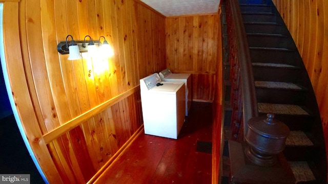 8354 Cumberland Rd, Springfield, WV 26763 - laundry area featuring independent washer and dryer, wooden walls, laundry area, and wood finished floors