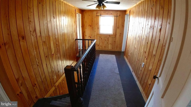 8354 Cumberland Rd, Springfield, WV 26763 - corridor with an upstairs landing, wood walls, and dark colored carpet