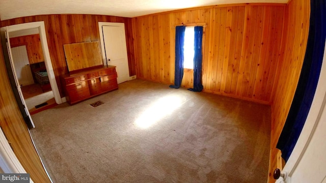 8354 Cumberland Rd, Springfield, WV 26763 - unfurnished bedroom with carpet floors, wood walls, and visible vents
