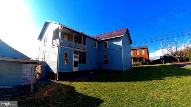8354 Cumberland Rd, Springfield, WV 26763 - rear view of house with a lawn, metal roof, and a balcony