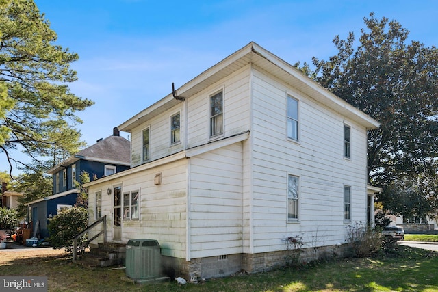 view of side of home with entry steps and central AC unit