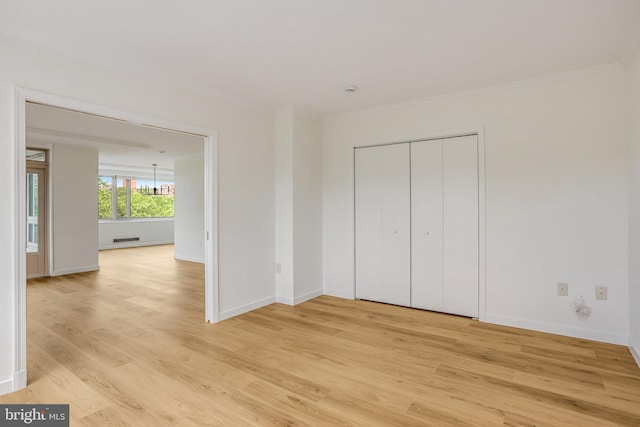 4101 Cathedral Ave NW Unit 1104, Washington, DC 20016 - unfurnished bedroom with light wood-style flooring, baseboards, ornamental molding, and a closet