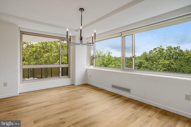 4101 Cathedral Ave NW Unit 1104, Washington, DC 20016 - unfurnished dining area with a chandelier, light wood-type flooring, and baseboards