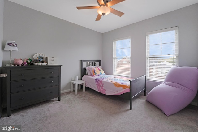 bedroom featuring baseboards, a ceiling fan, and light colored carpet