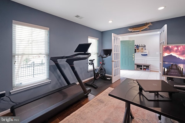 workout room featuring visible vents, baseboards, recessed lighting, wood finished floors, and french doors