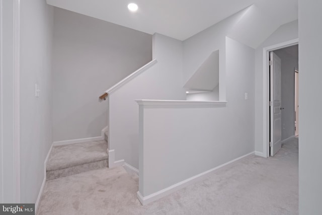 stairway featuring carpet and baseboards