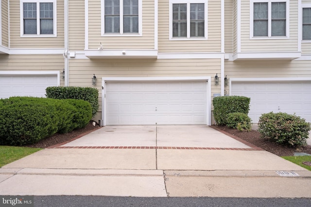 garage with concrete driveway