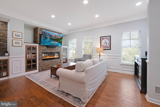 living room with plenty of natural light, hardwood / wood-style flooring, and a fireplace