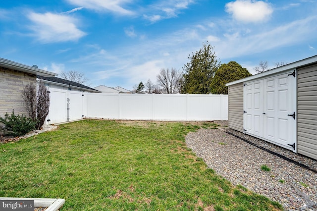 view of yard with an outbuilding and a fenced backyard