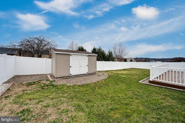 view of yard with a storage unit, an outdoor structure, and a fenced backyard