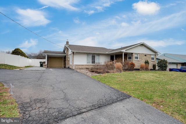 single story home featuring a front lawn, fence, a chimney, driveway, and an attached garage