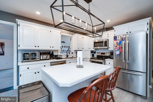 kitchen featuring a sink, stainless steel appliances, and white cabinets