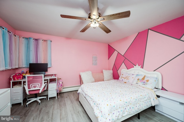 bedroom featuring ceiling fan, baseboard heating, and wood finished floors